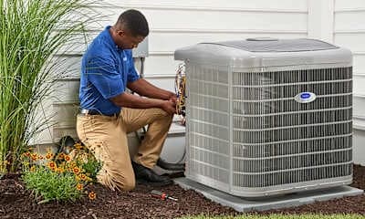 Technician inspecting residential air conditioning unit