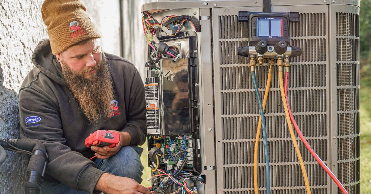 Professional HVAC technician servicing heating and cooling system in Queens and Brooklyn NY