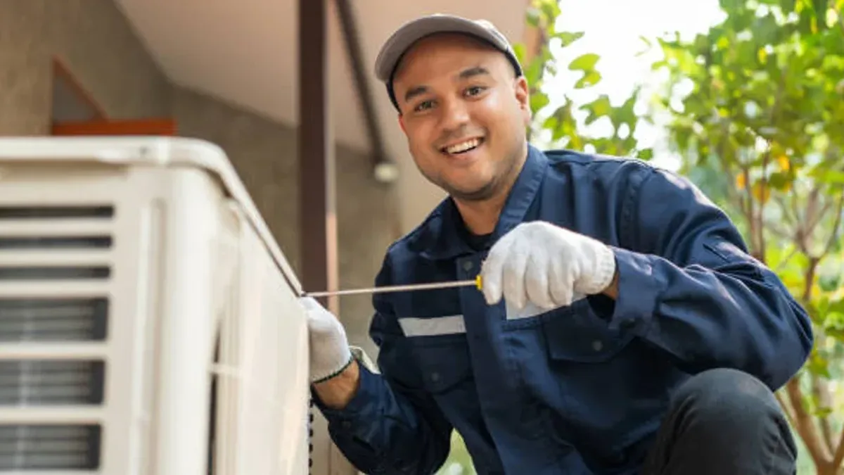 AC repair technician servicing an outdoor condenser in New York